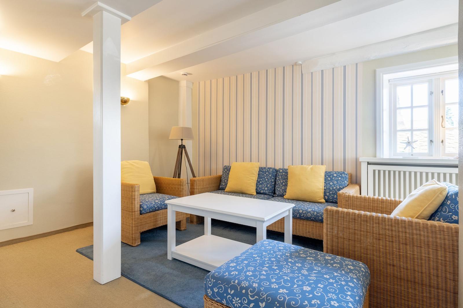 Living room with seating group, table, and window