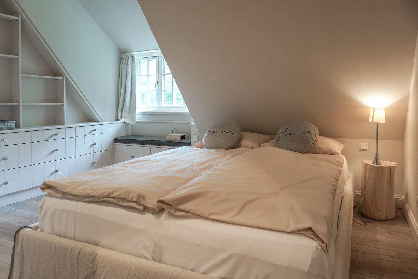 Bedroom with double bed, nightstand, and window