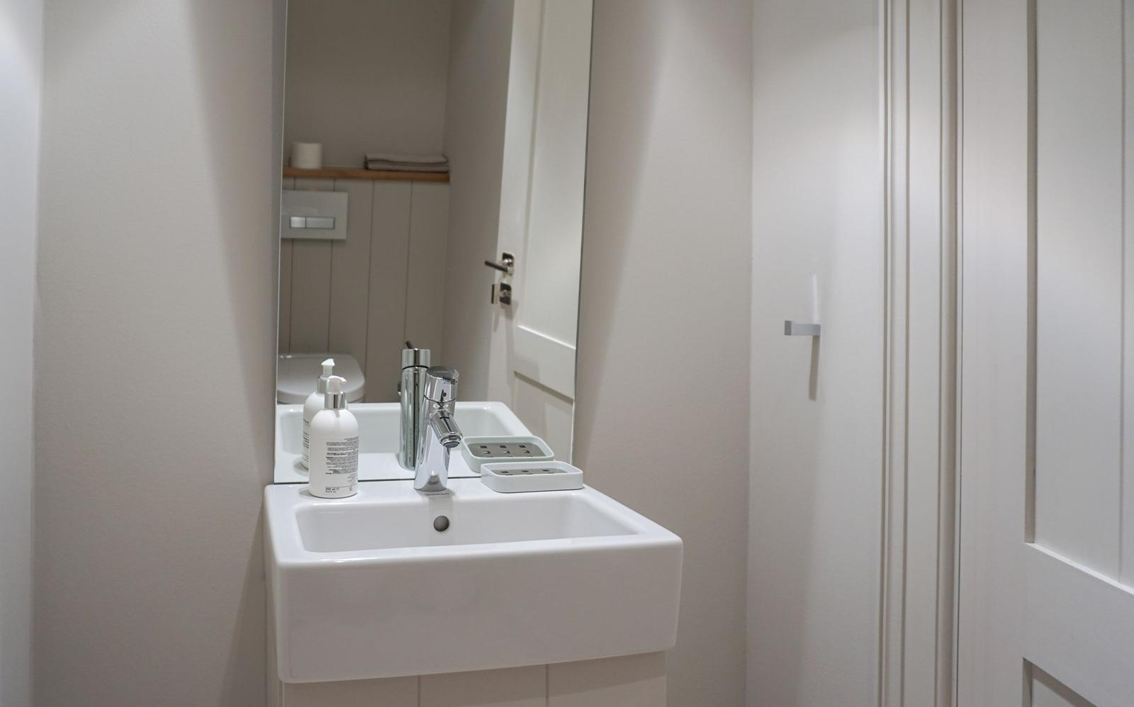 Bathroom with sink, mirror, and toilet