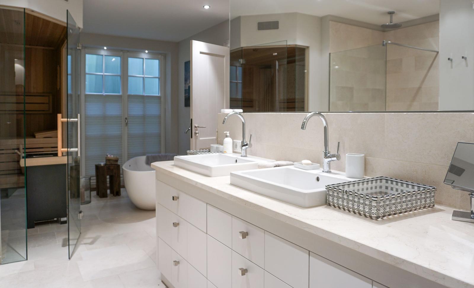 Double sink with mirrors, shower, and sauna in bathroom