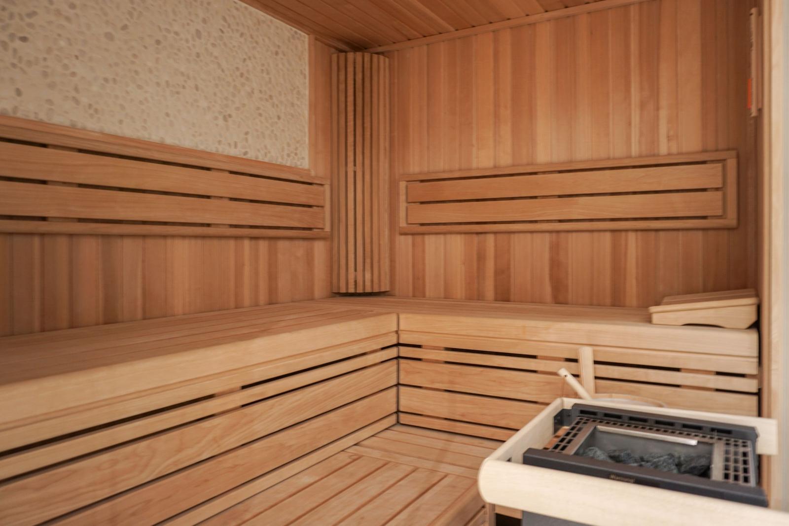 Sauna with wooden bench and heater