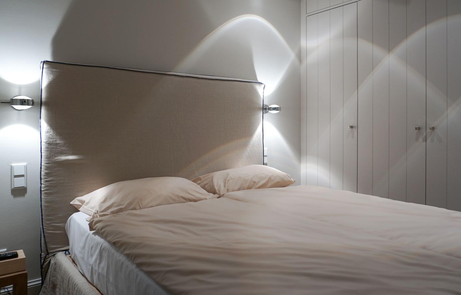 Bedroom with bed, nightstand, and wardrobe.