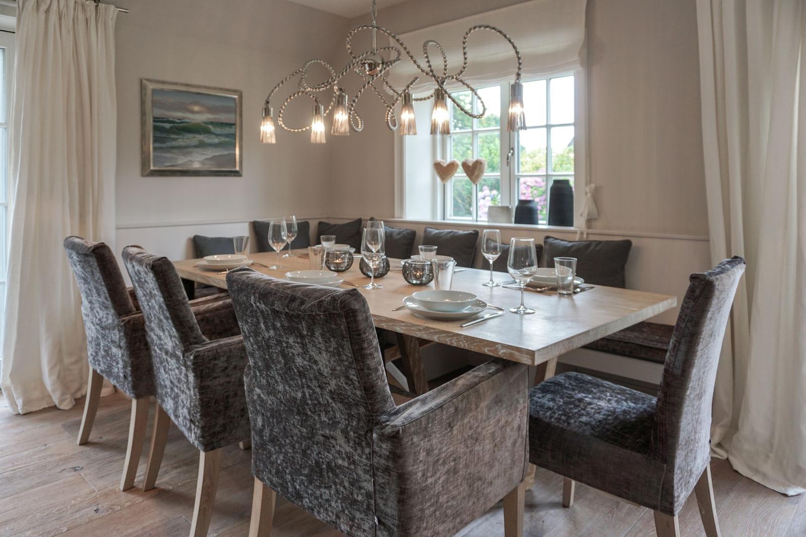 Dining room with wooden table, chairs, and window view