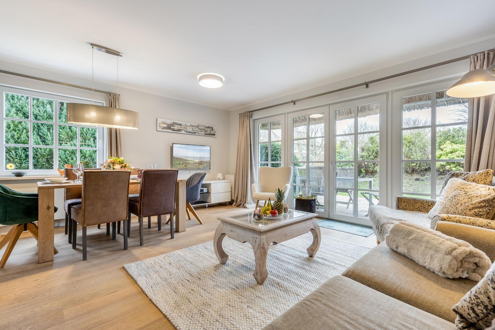 Living and dining area with view of terrace and garden.