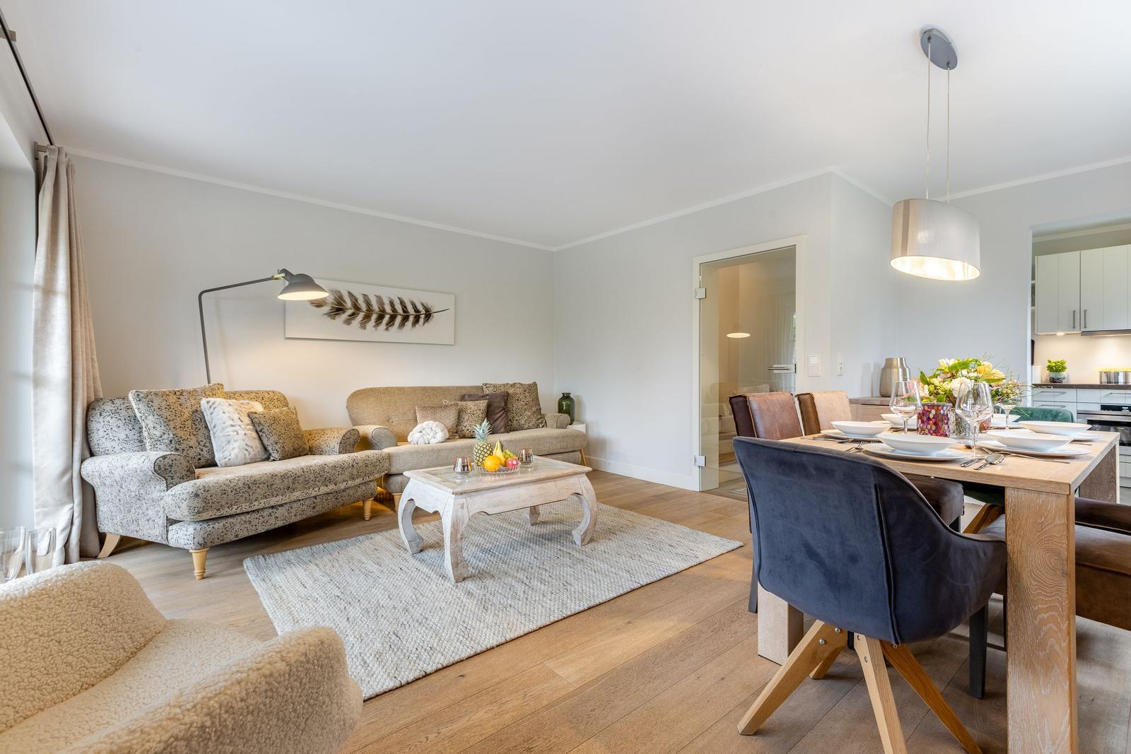 Living and dining area with sofa, table, and chairs.