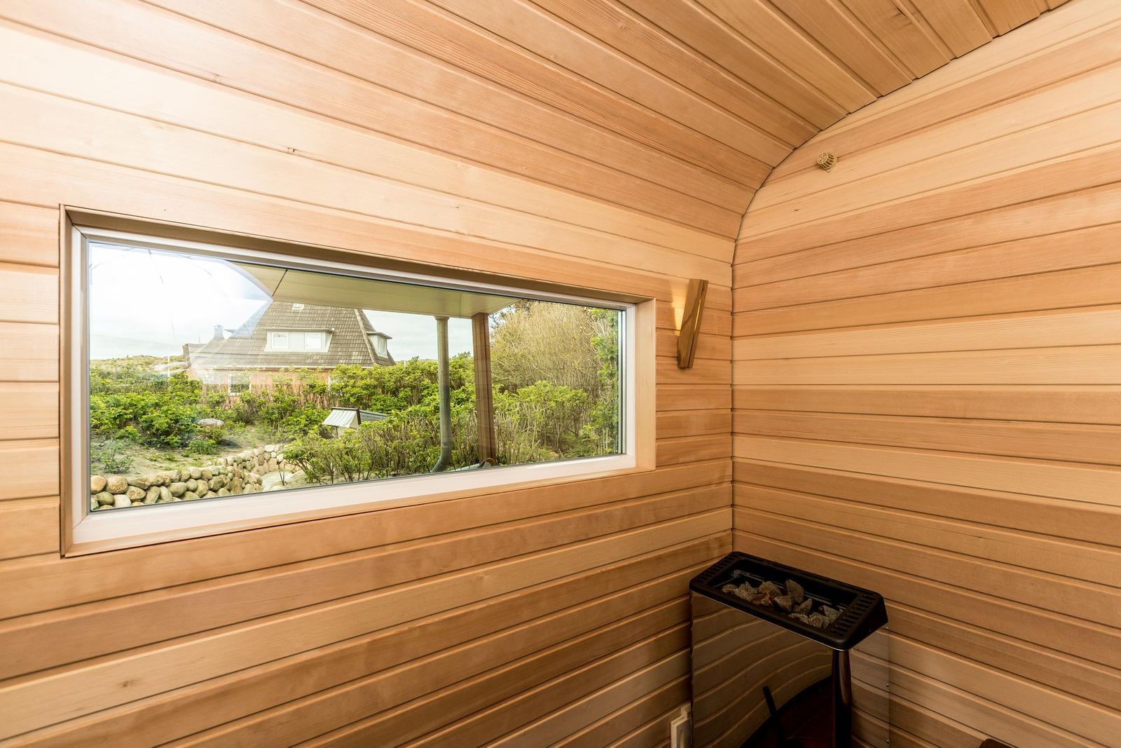 Sauna mit Holzwand und Fensterblick auf Garten