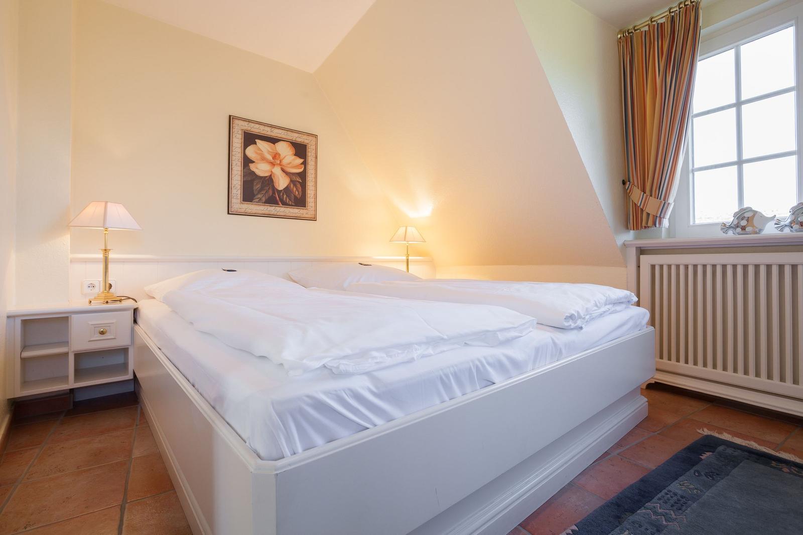 Bedroom with double bed, nightstand, and window