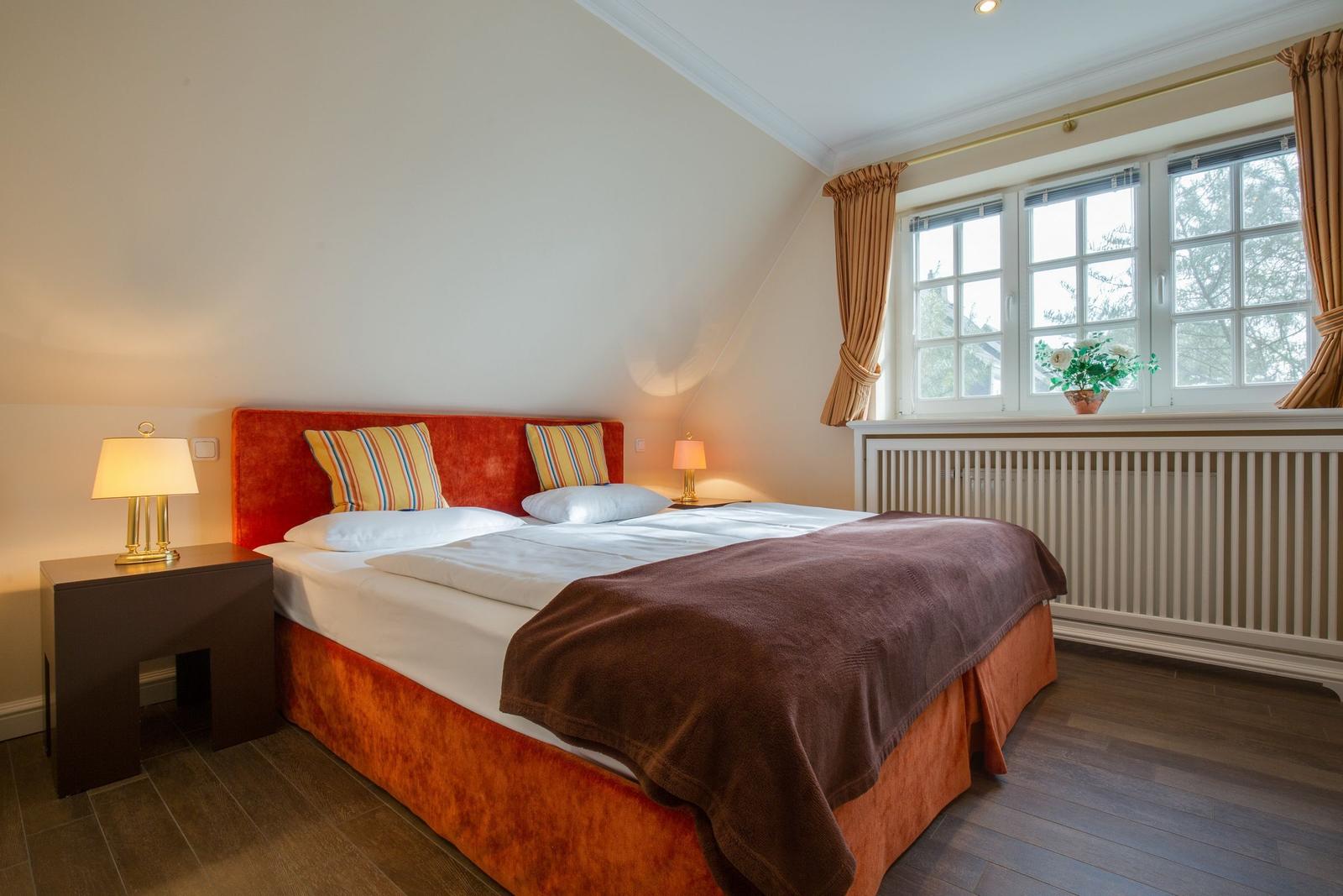 Bedroom with double bed, nightstands, and window.