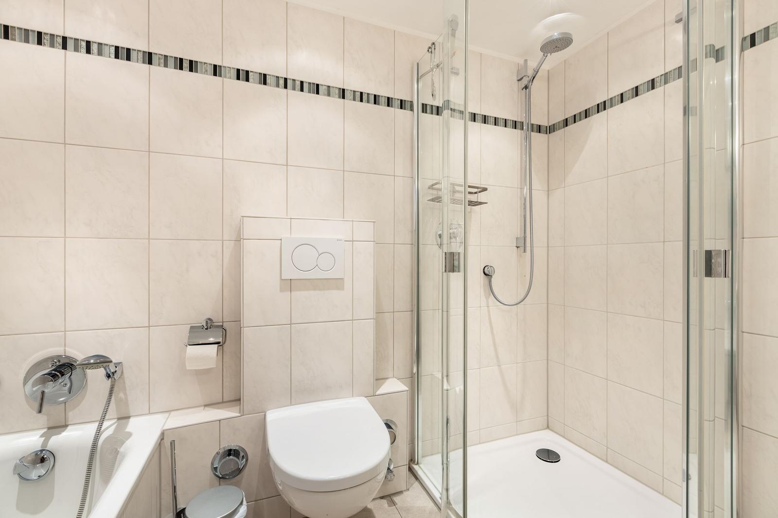 Bathroom with shower, toilet, and bathtub.