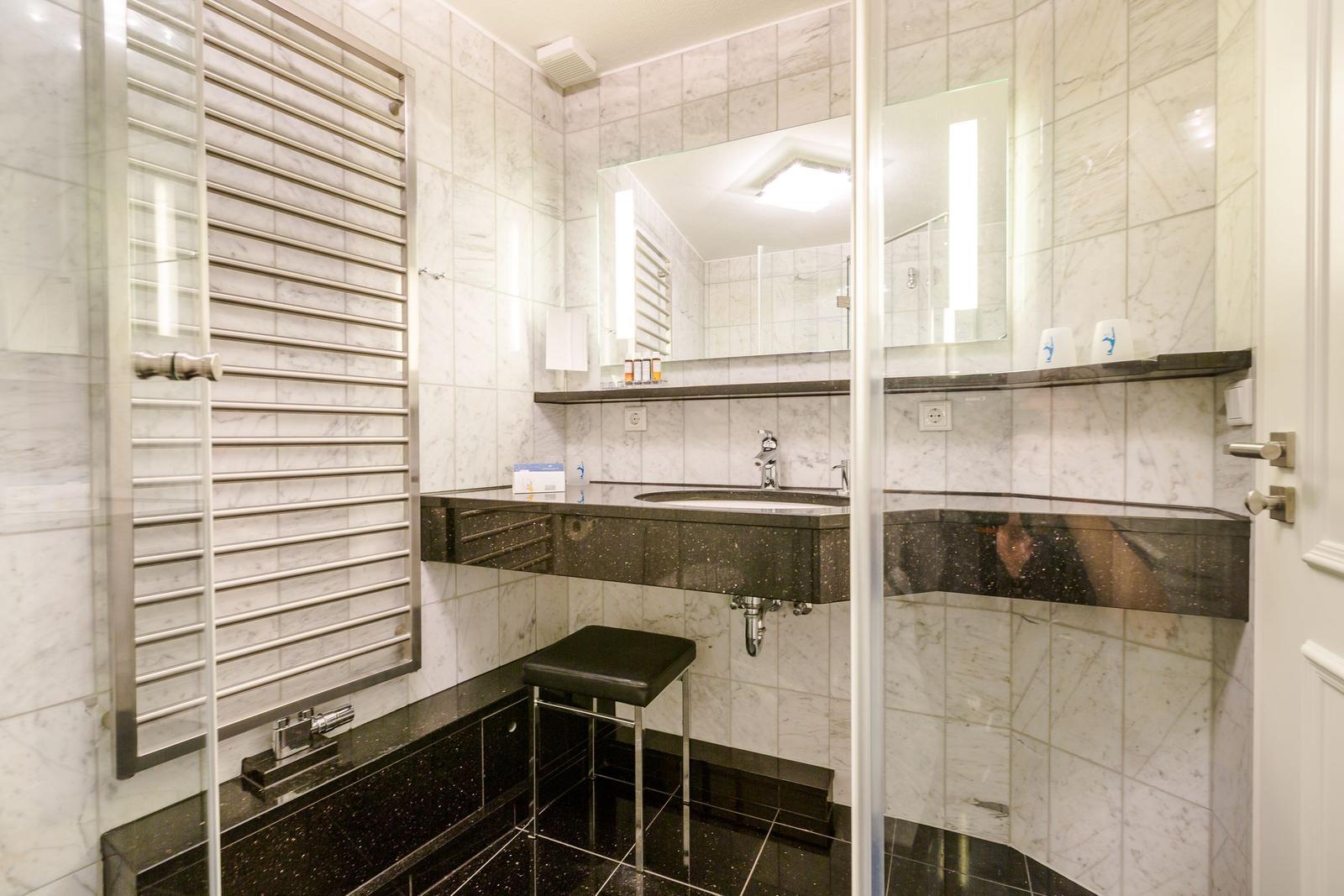 Bathroom with marble wall, sink and heater