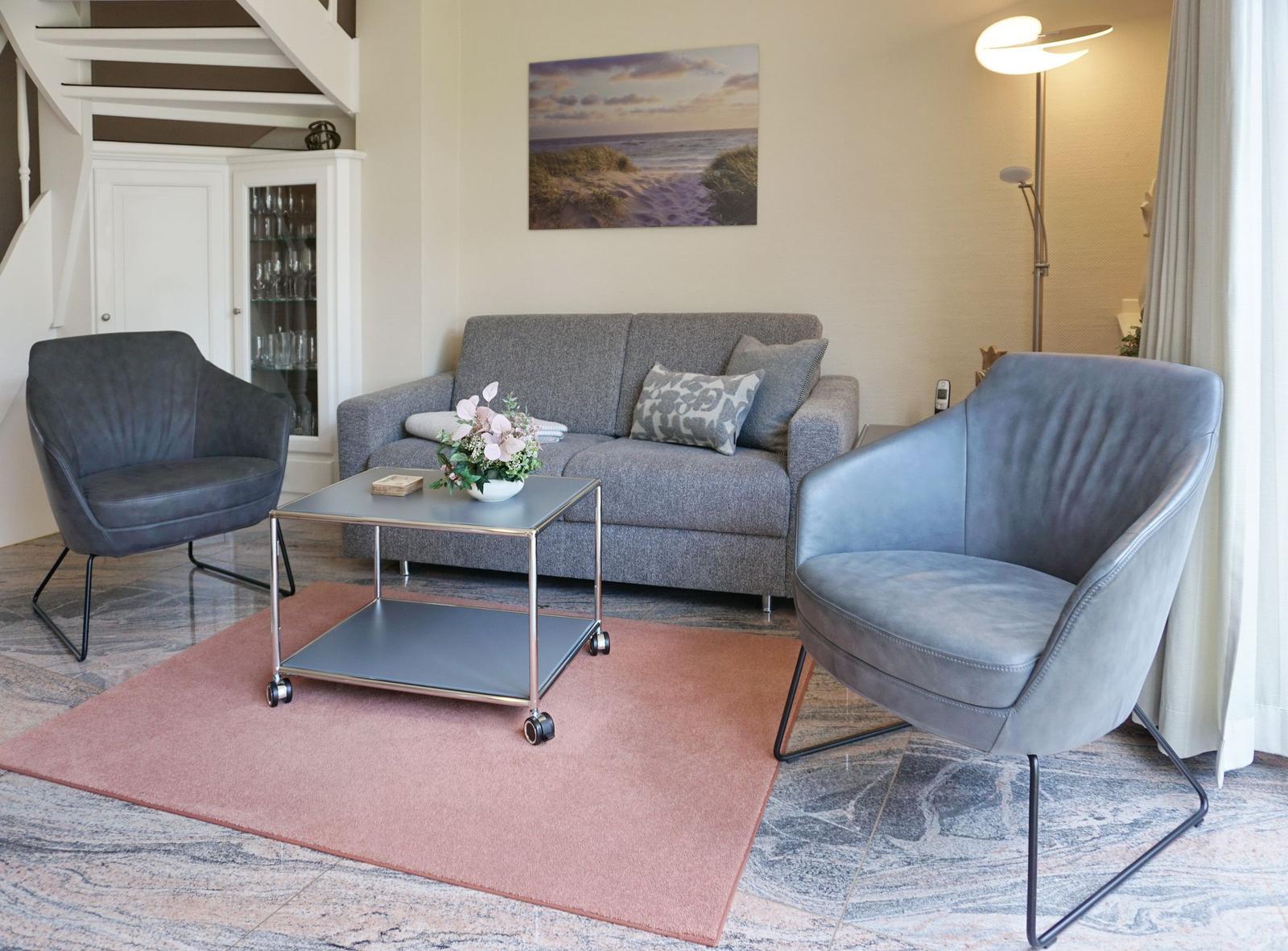 Living room with gray sofa, two chairs, and a coffee table.