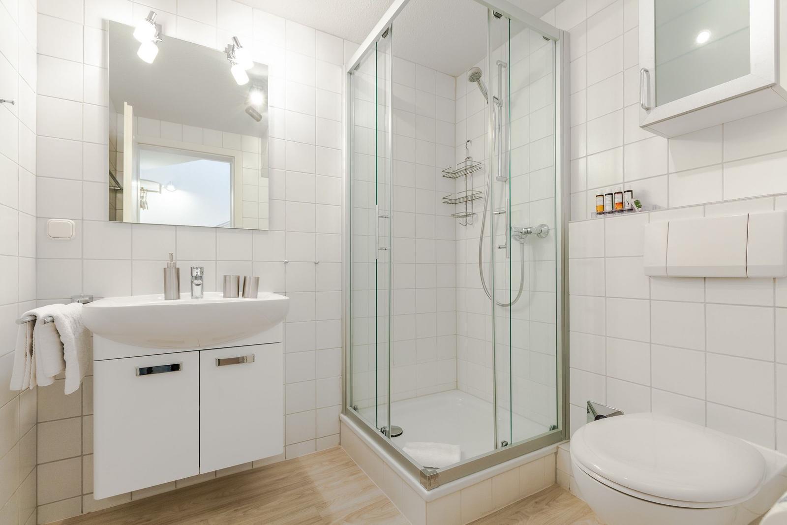 Bathroom with shower, sink, and toilet.