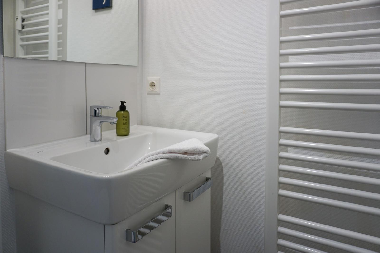 Sink with mirror, towel, and soap dispenser