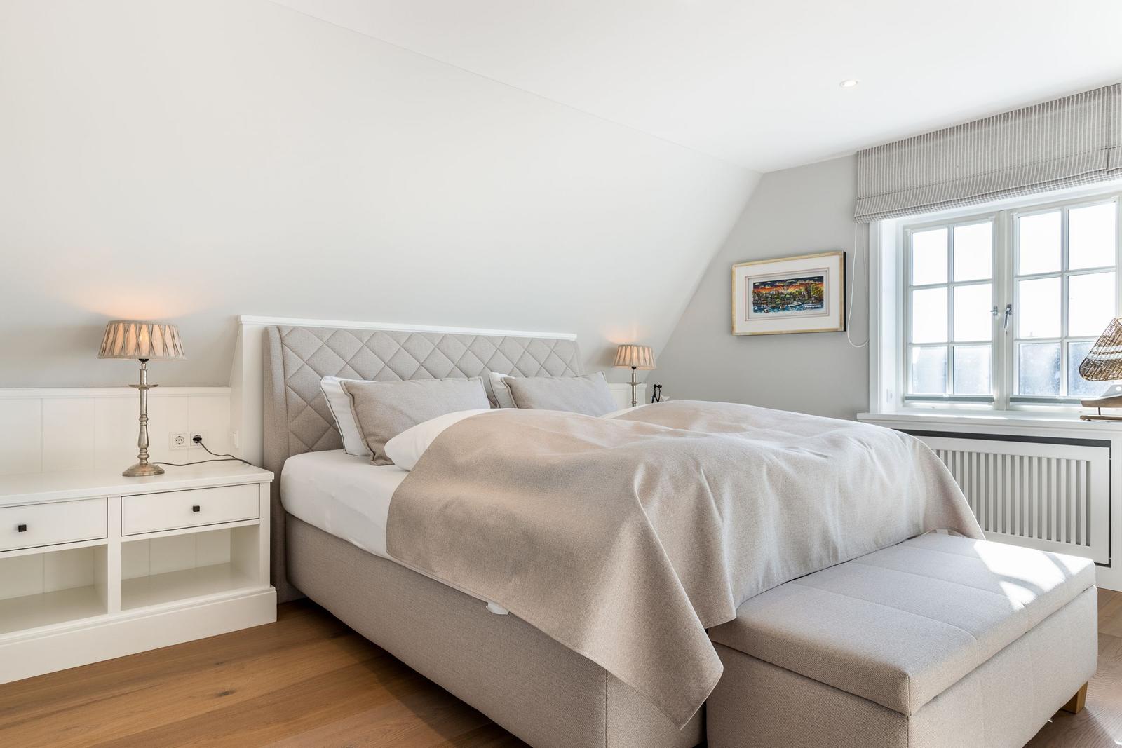 Bedroom with bed, nightstands, and window