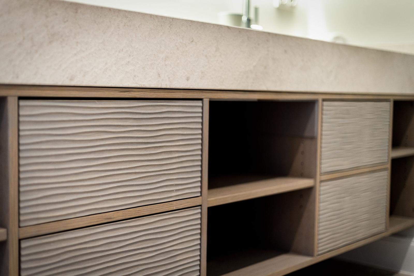 Modern cabinet with wavy fronts and open shelves.