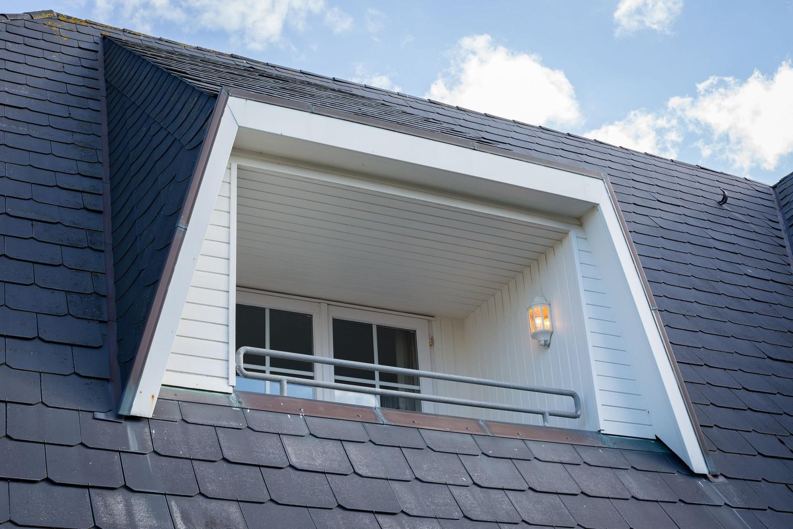 Attic window with balcony and outdoor lighting
