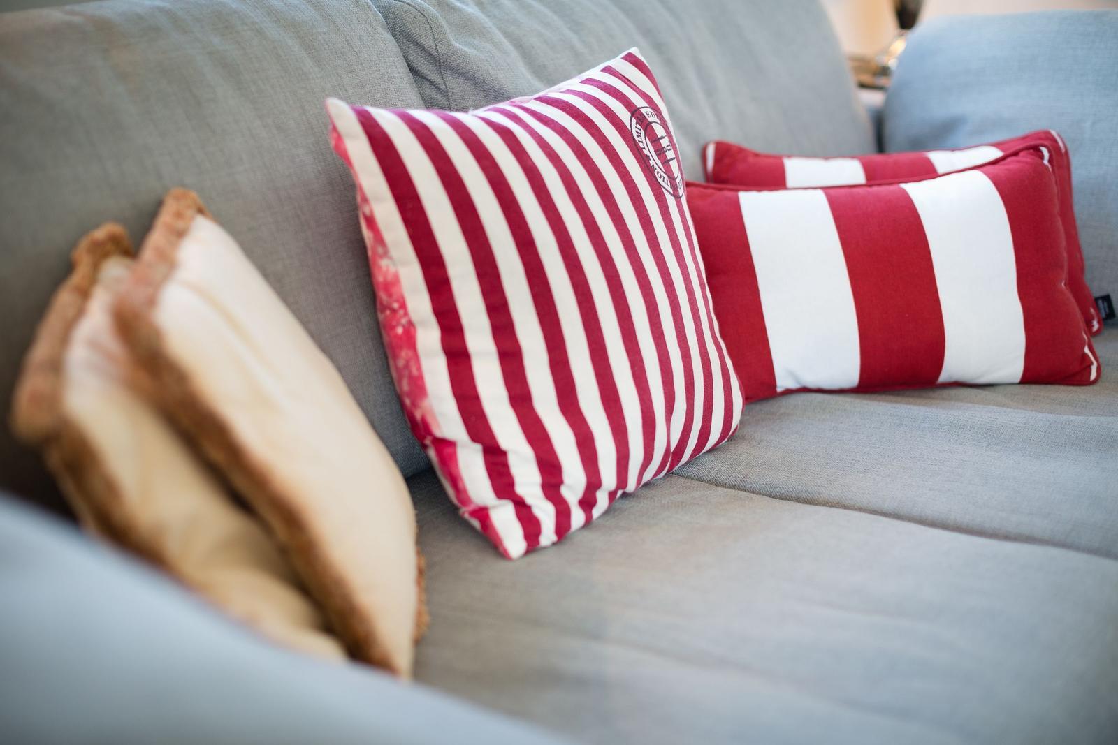 Gray sofa with red and white cushions