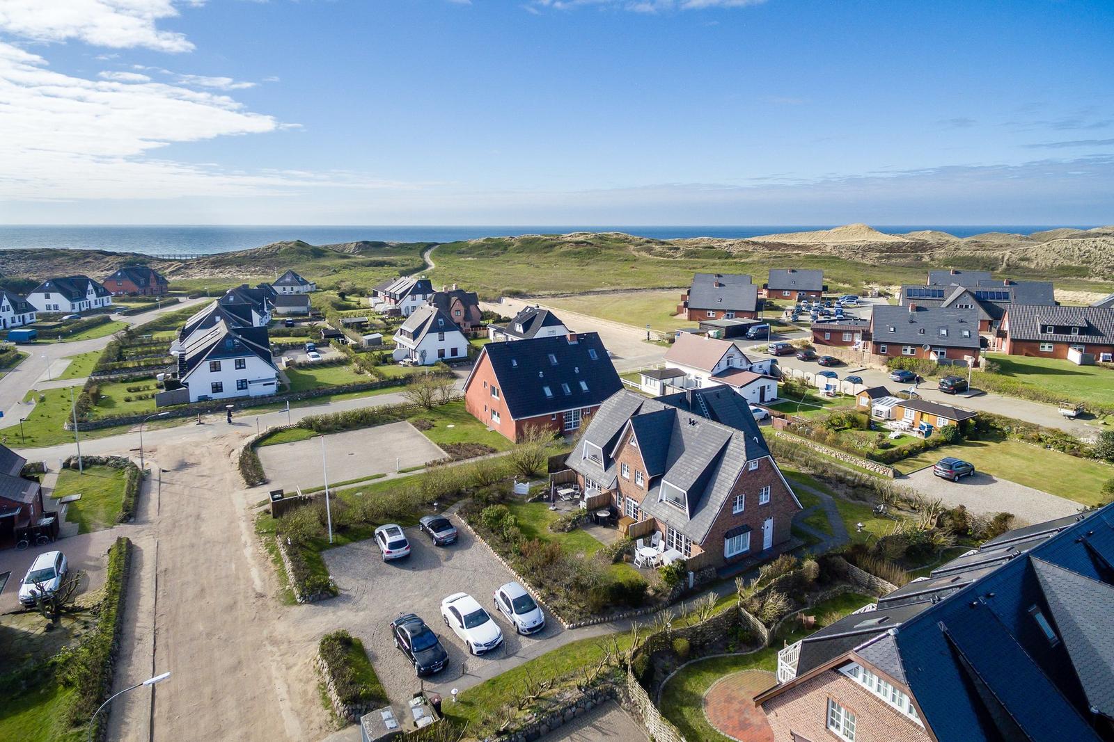 Village with houses and beach in background
