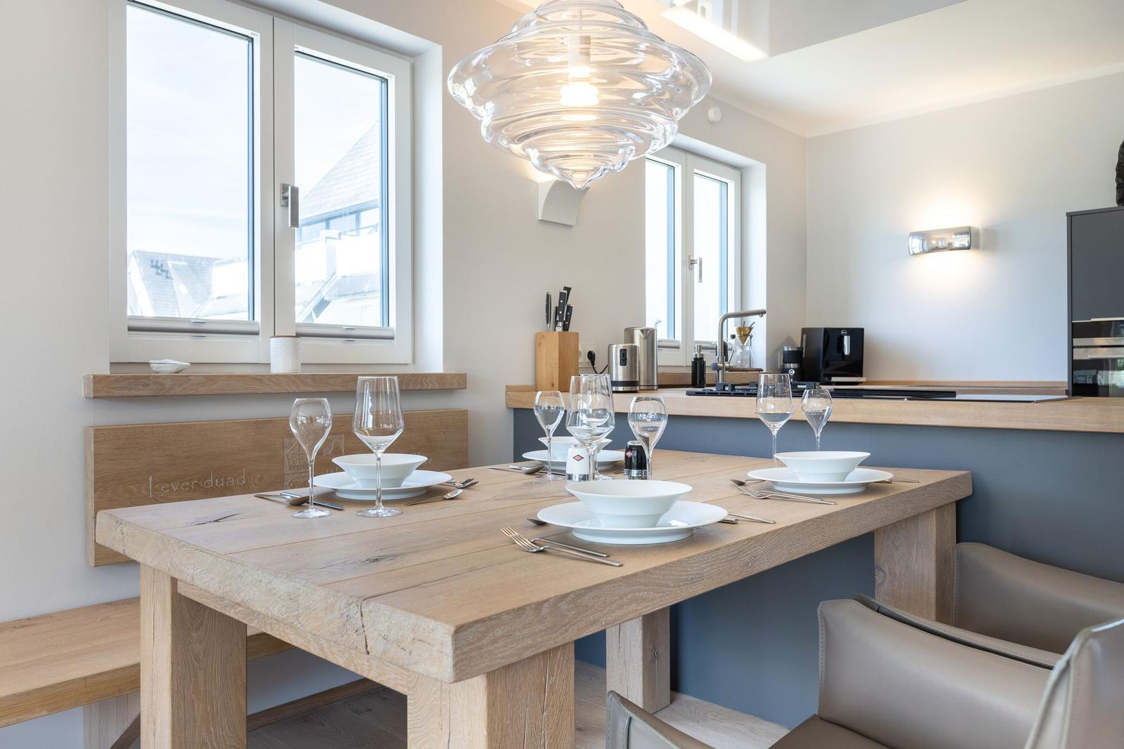 Wooden table with chairs and windows in dining area
