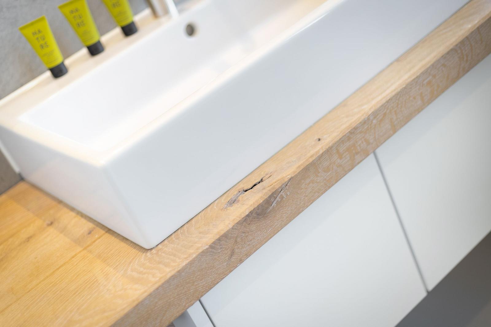 Sink on wooden surface with soap dispenser