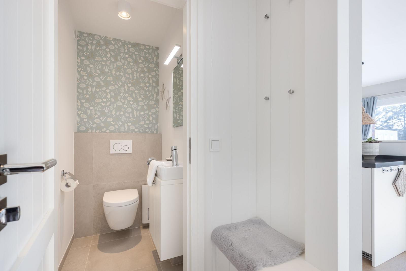 Bathroom with toilet, sink, and shower