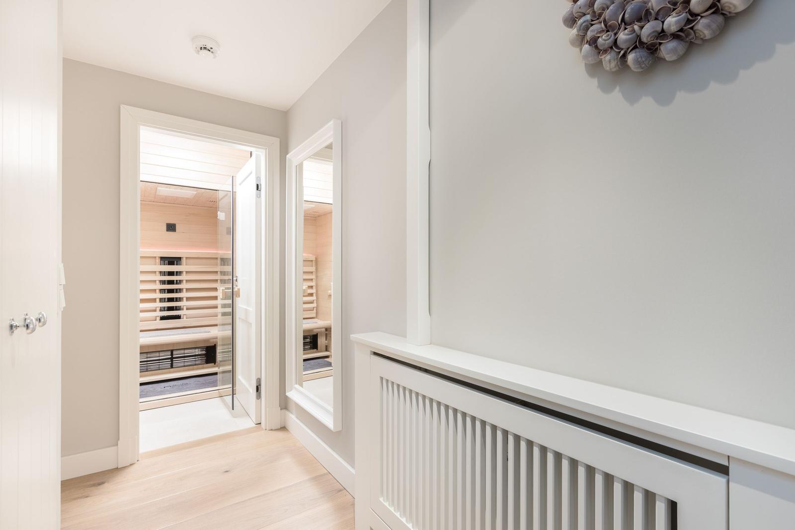 Sauna with wooden wall and mirror on the wall