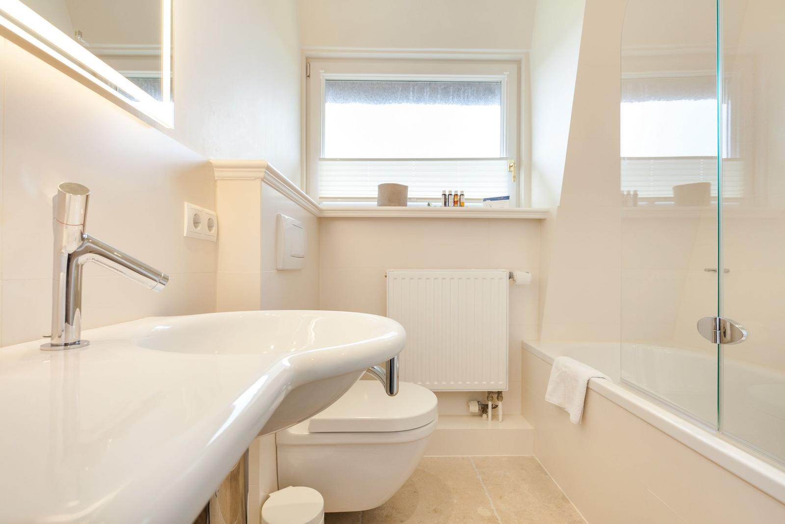 Bathroom with sink, toilet, and shower