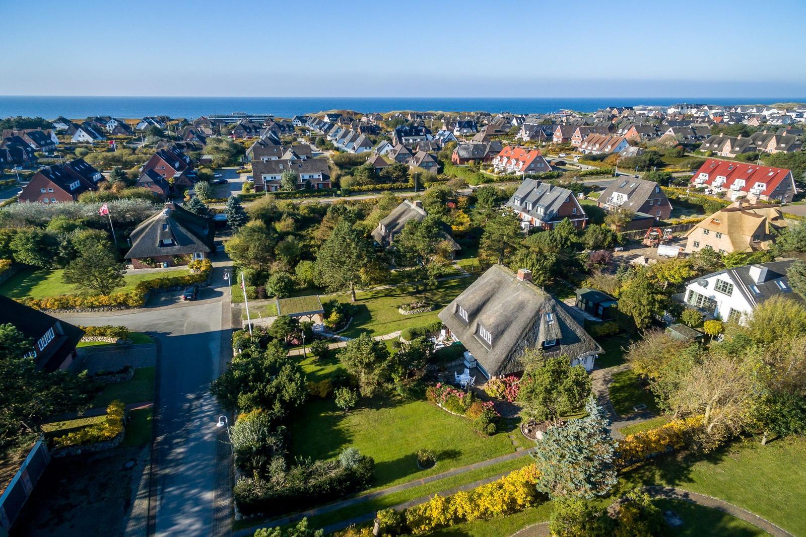 Village with traditional houses and view of the sea.