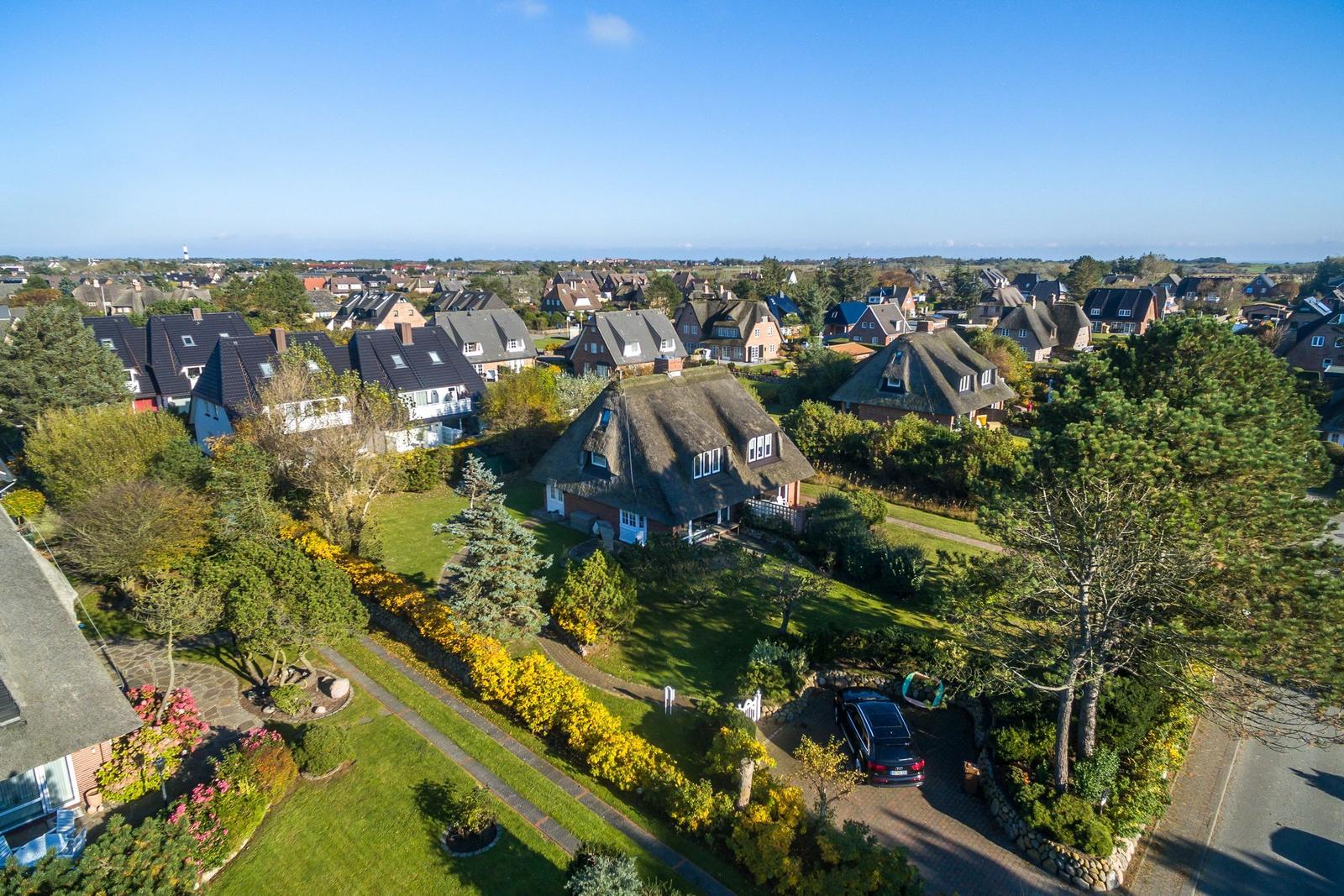 House with thatched roof and garden in quiet residential area