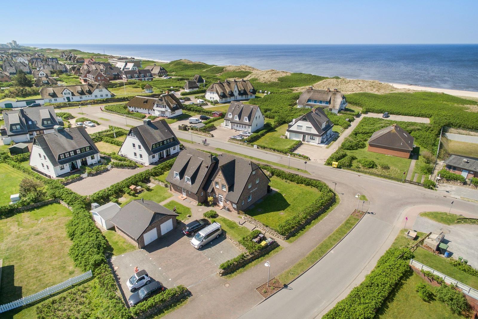 Dorf mit Häusern und Strand im Hintergrund