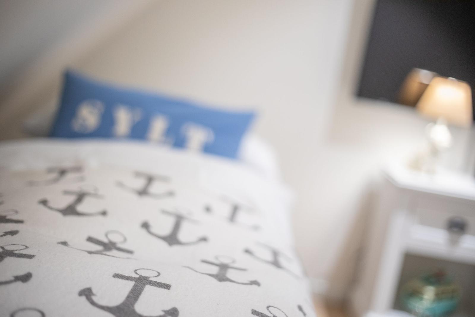 Bedroom with bed, pillow, and nightstand