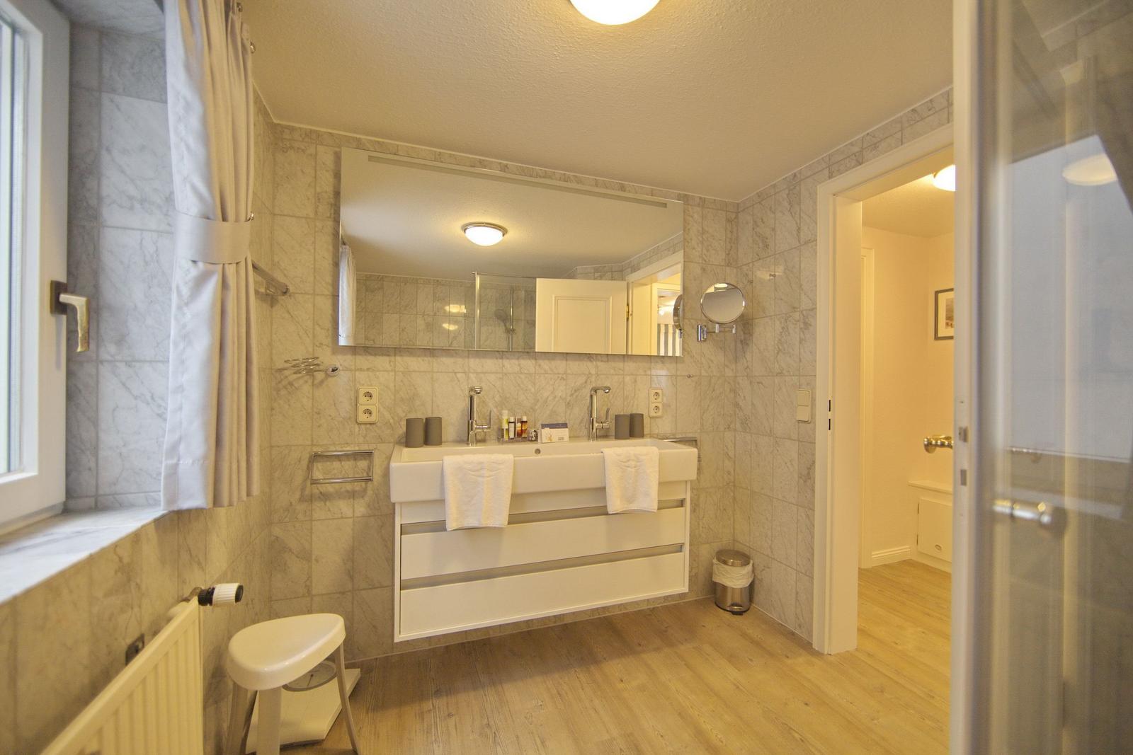 Bathroom with sink, mirror, and shower