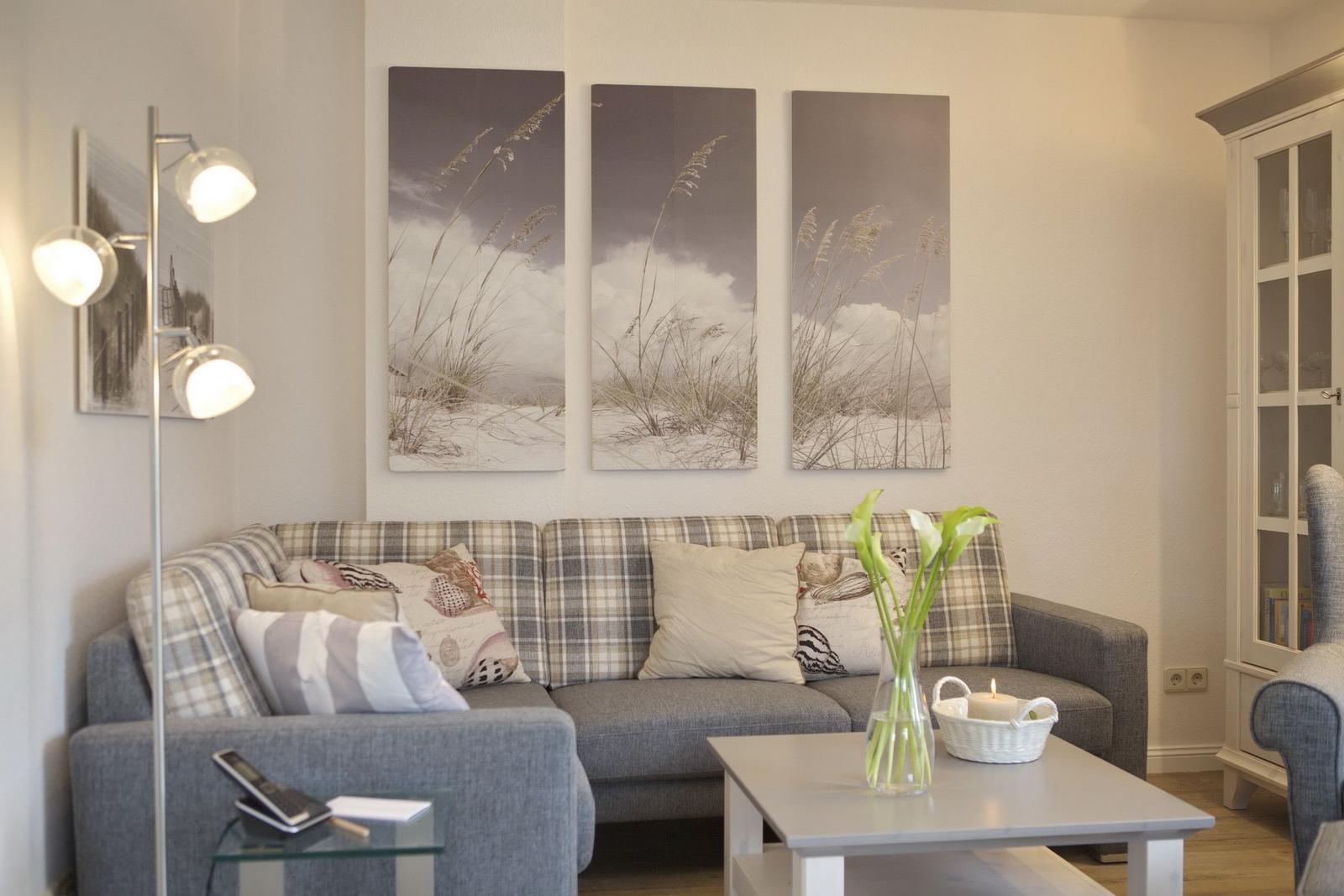 Living room with sofa, coffee table, and wall art.