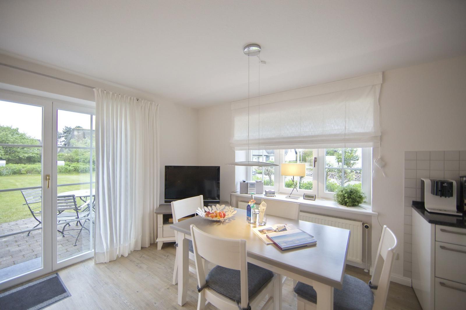 Dining room with table, chairs, and view of garden