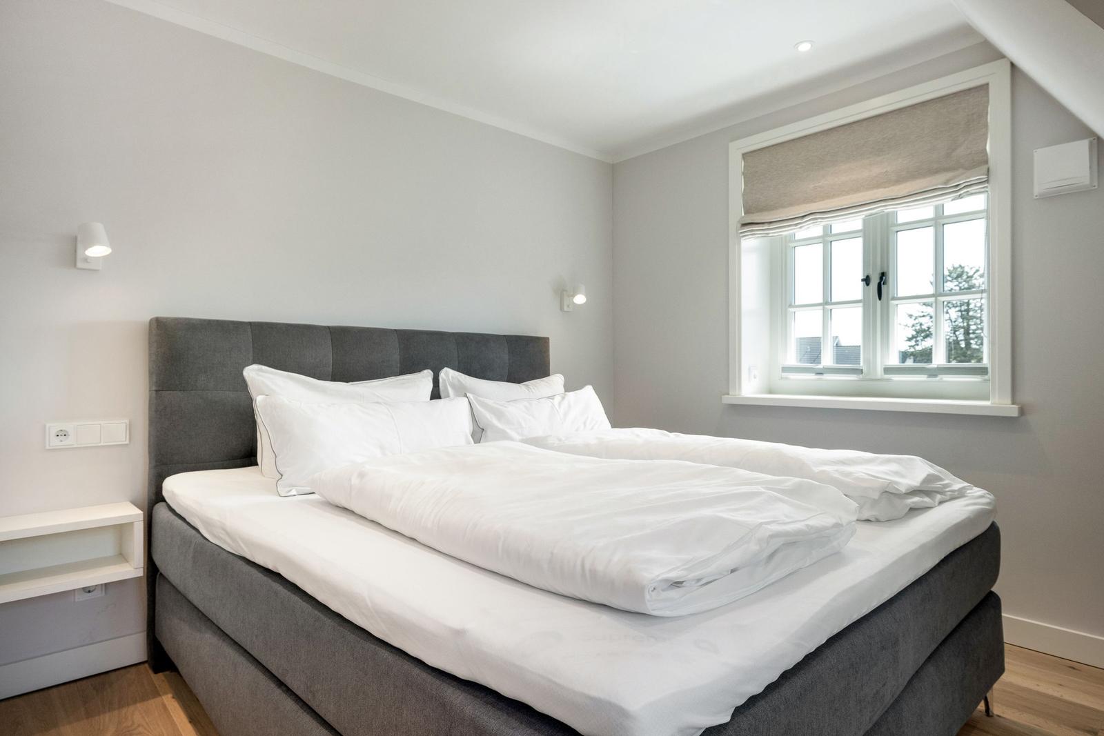 Bedroom with double bed, window and nightstand