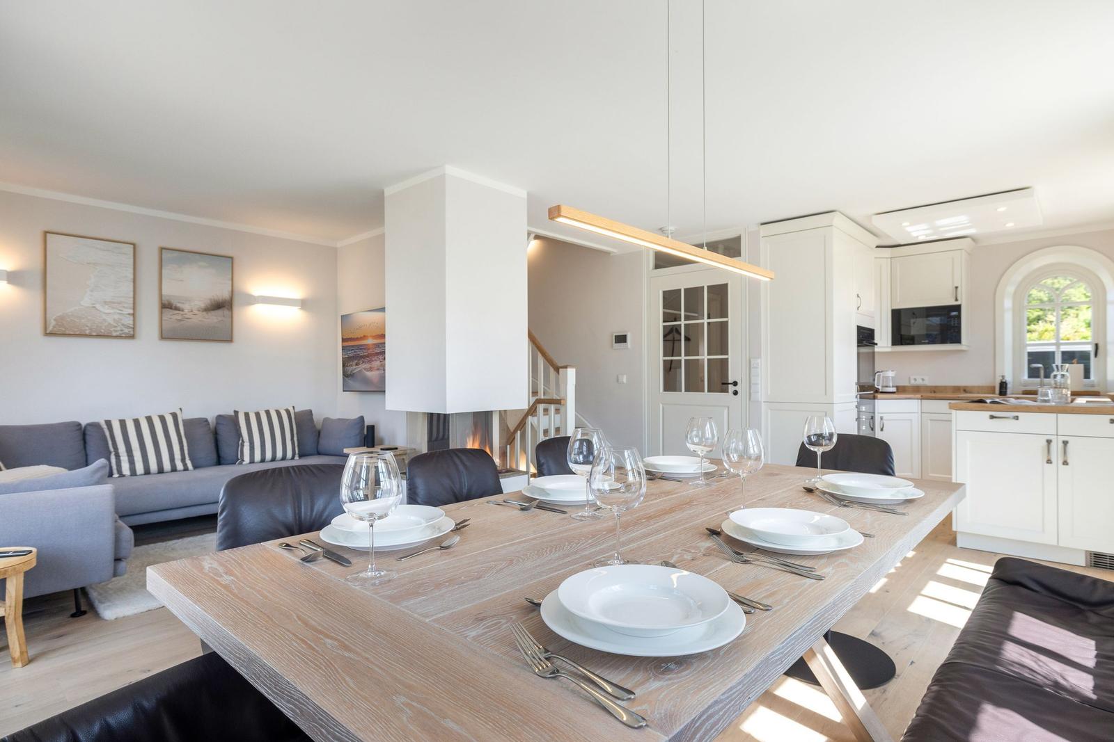 Dining area with table, chairs, and view into kitchen and living room.