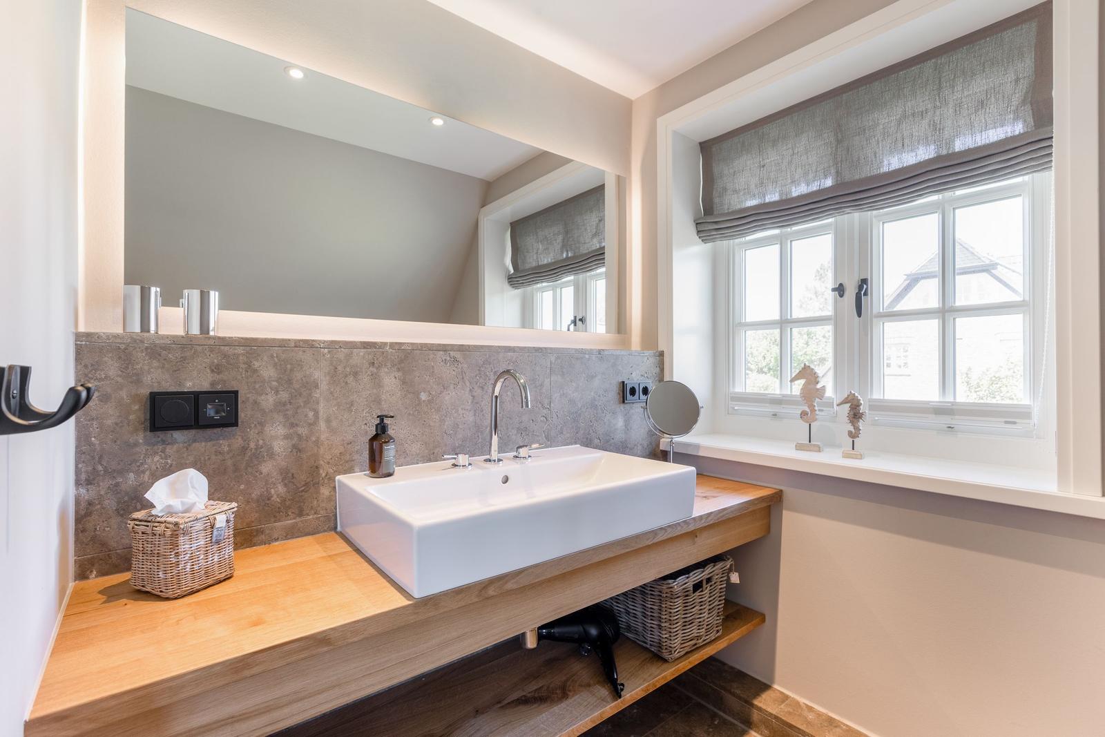 Sink with mirror and window with seahorse figurines