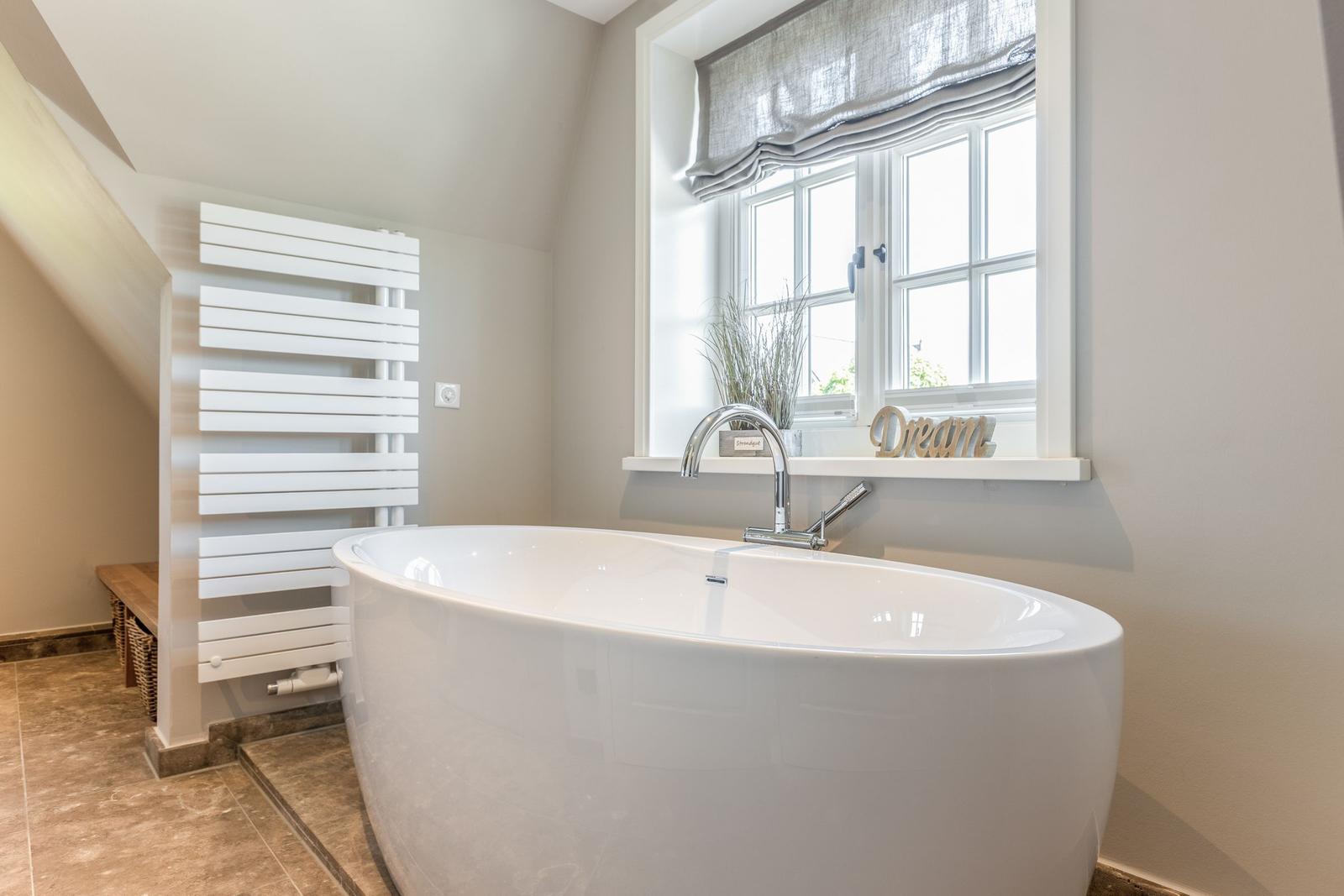 Freestanding bathtub with window and heater