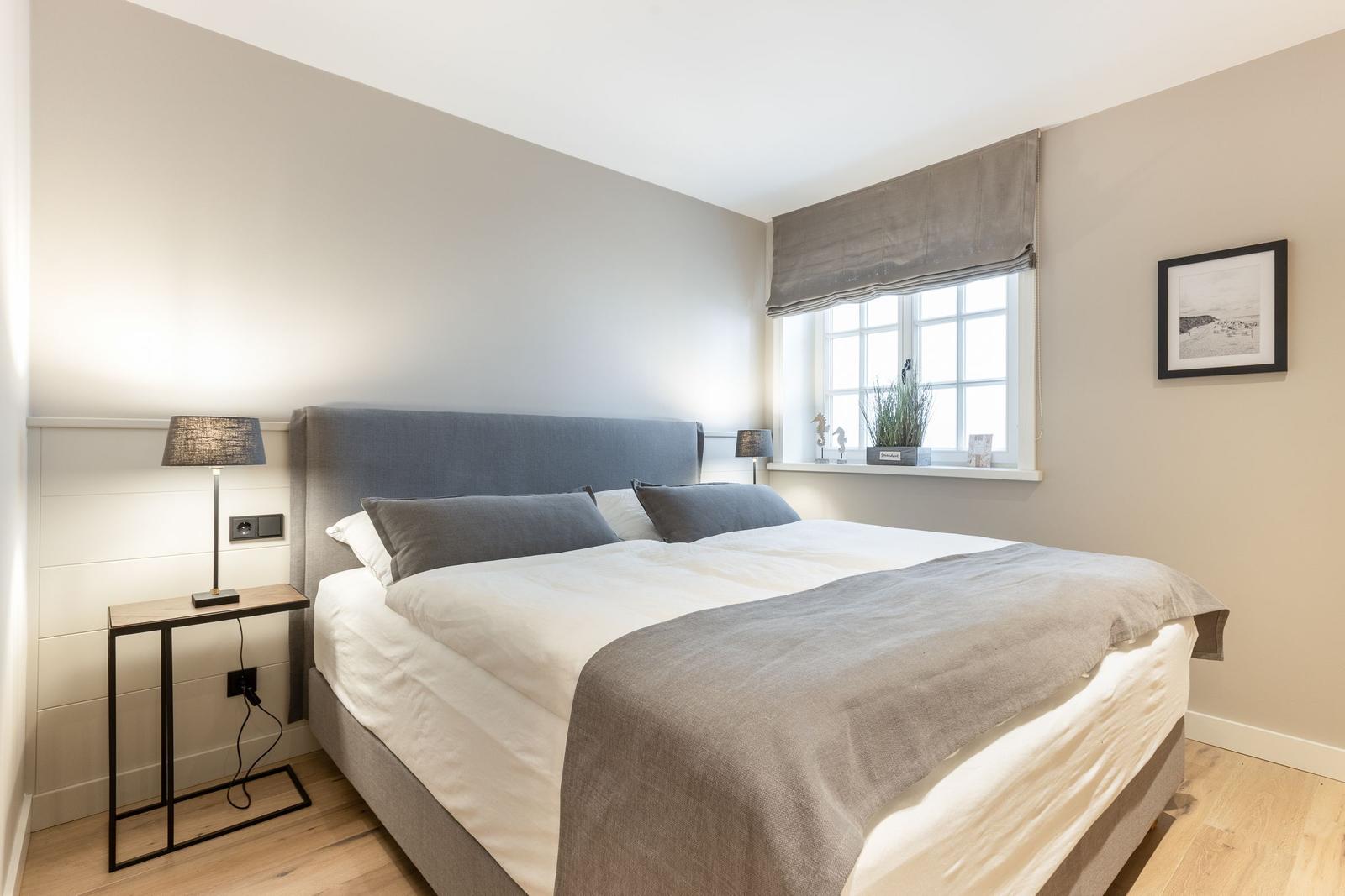Bedroom with bed, nightstand, and window