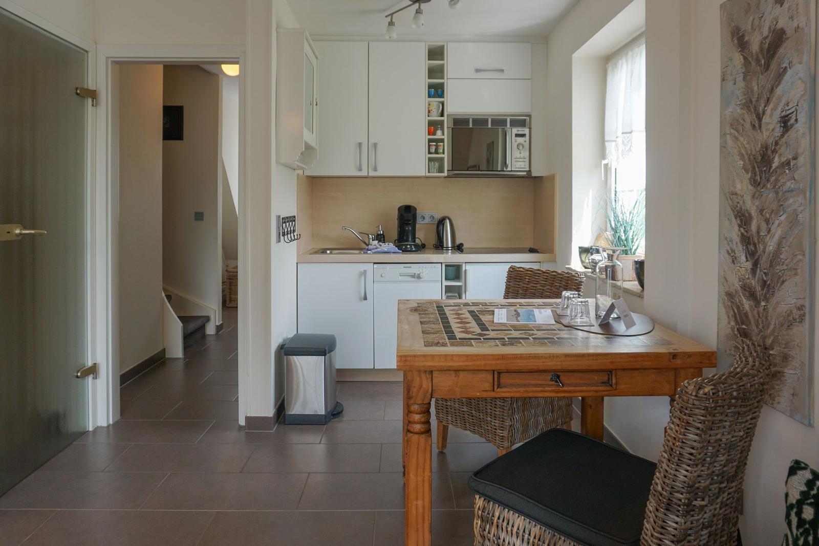 Kitchen with dining table, microwave, and dishwasher.