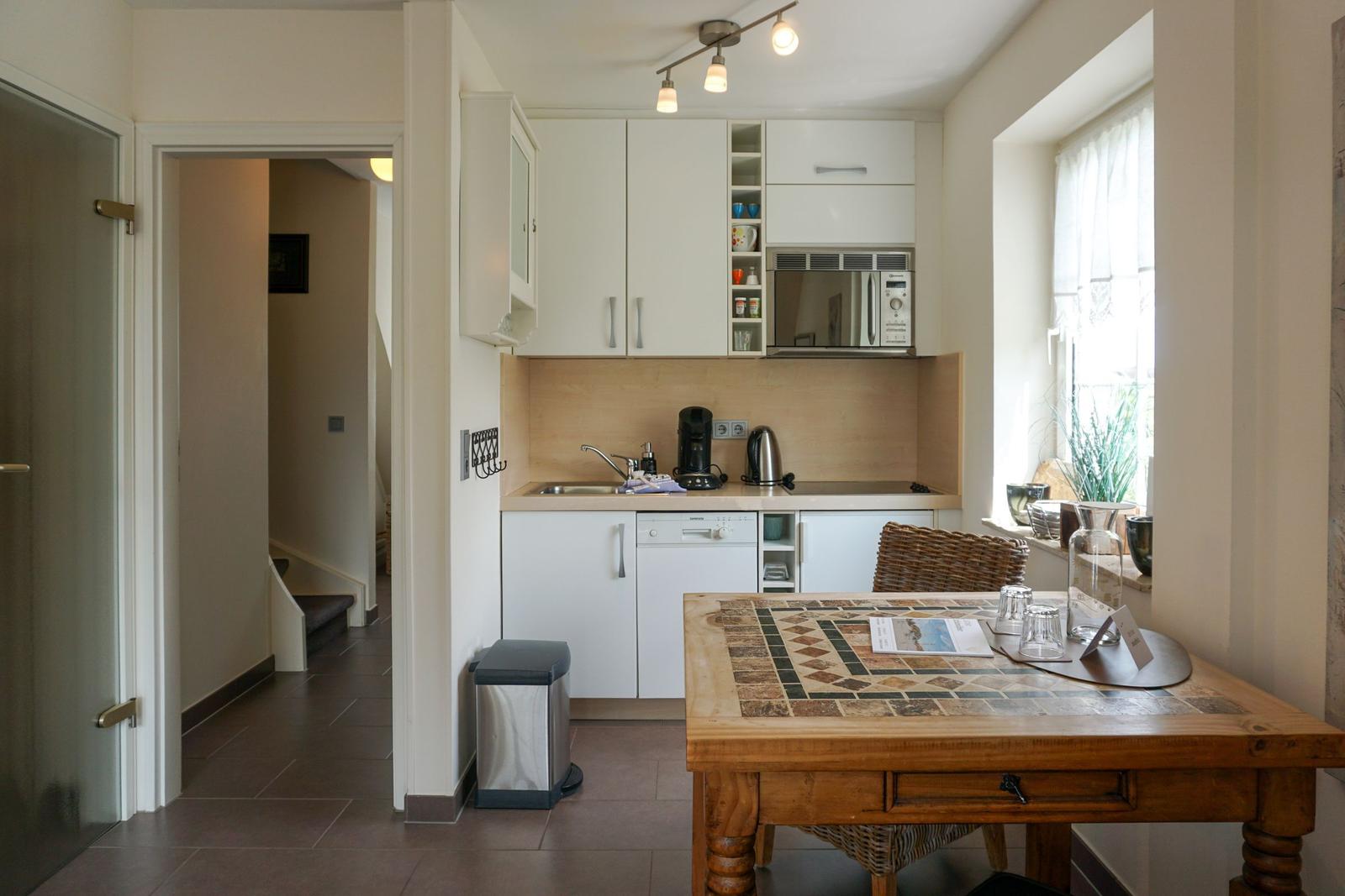 Kitchen with table, microwave, and dishwasher