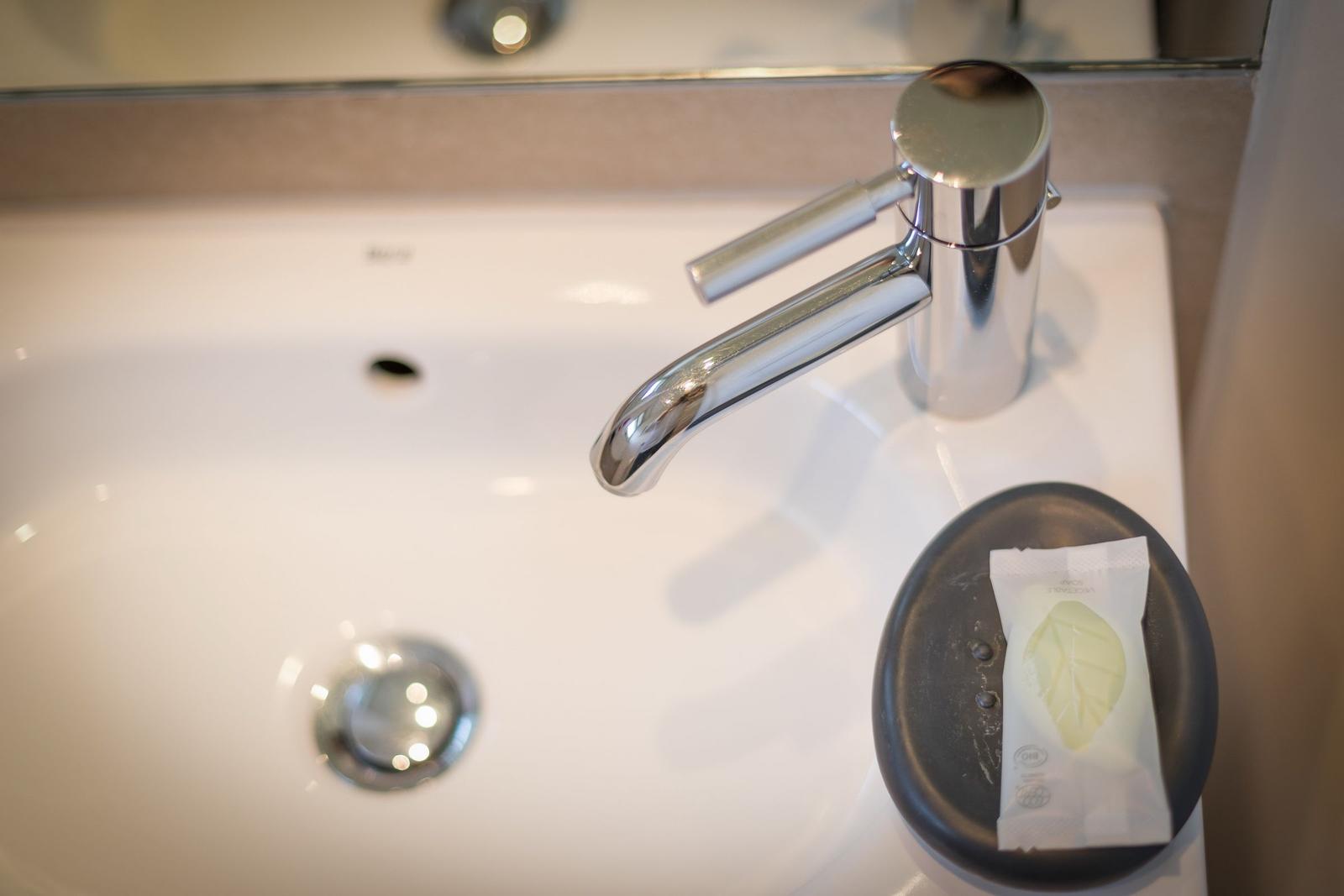 Sink with chrome faucet and soap dispenser