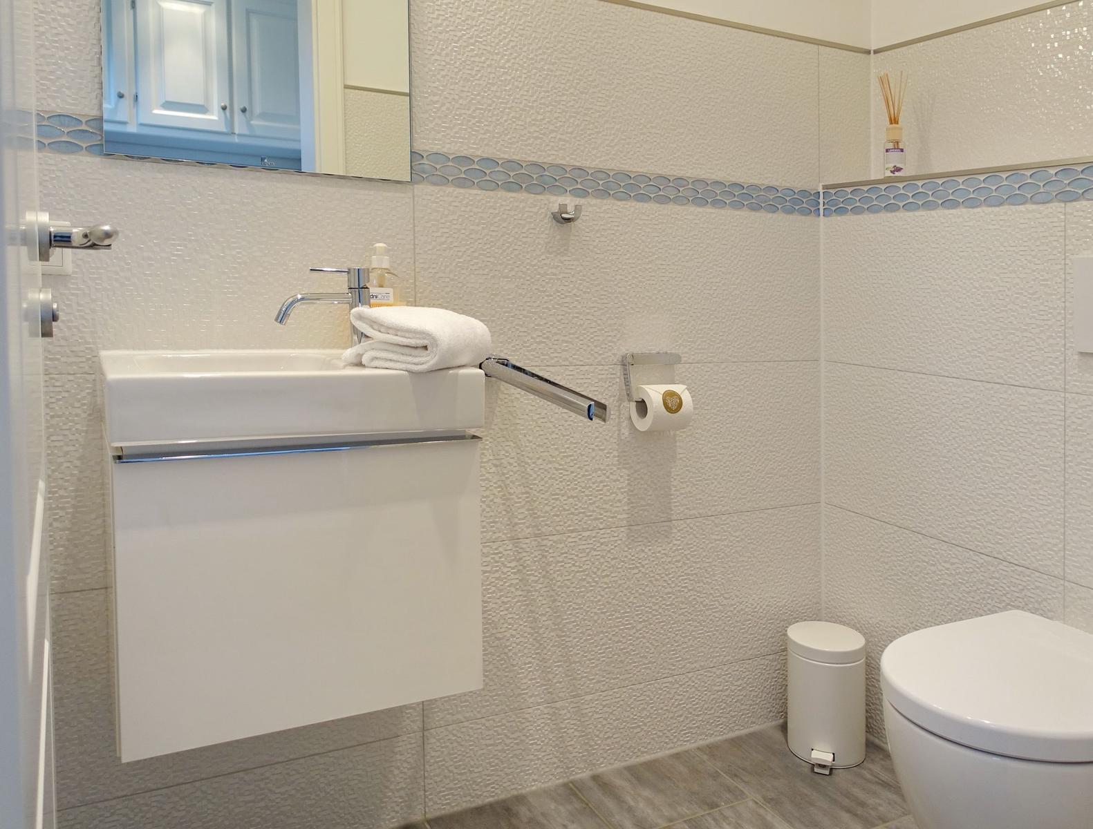 Bathroom with sink, mirror and toilet
