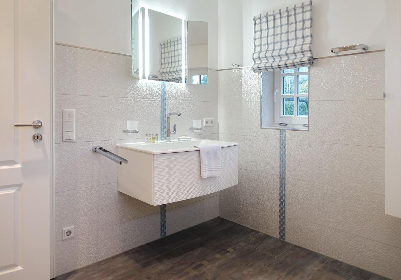 Bathroom with sink, mirror, and window.
