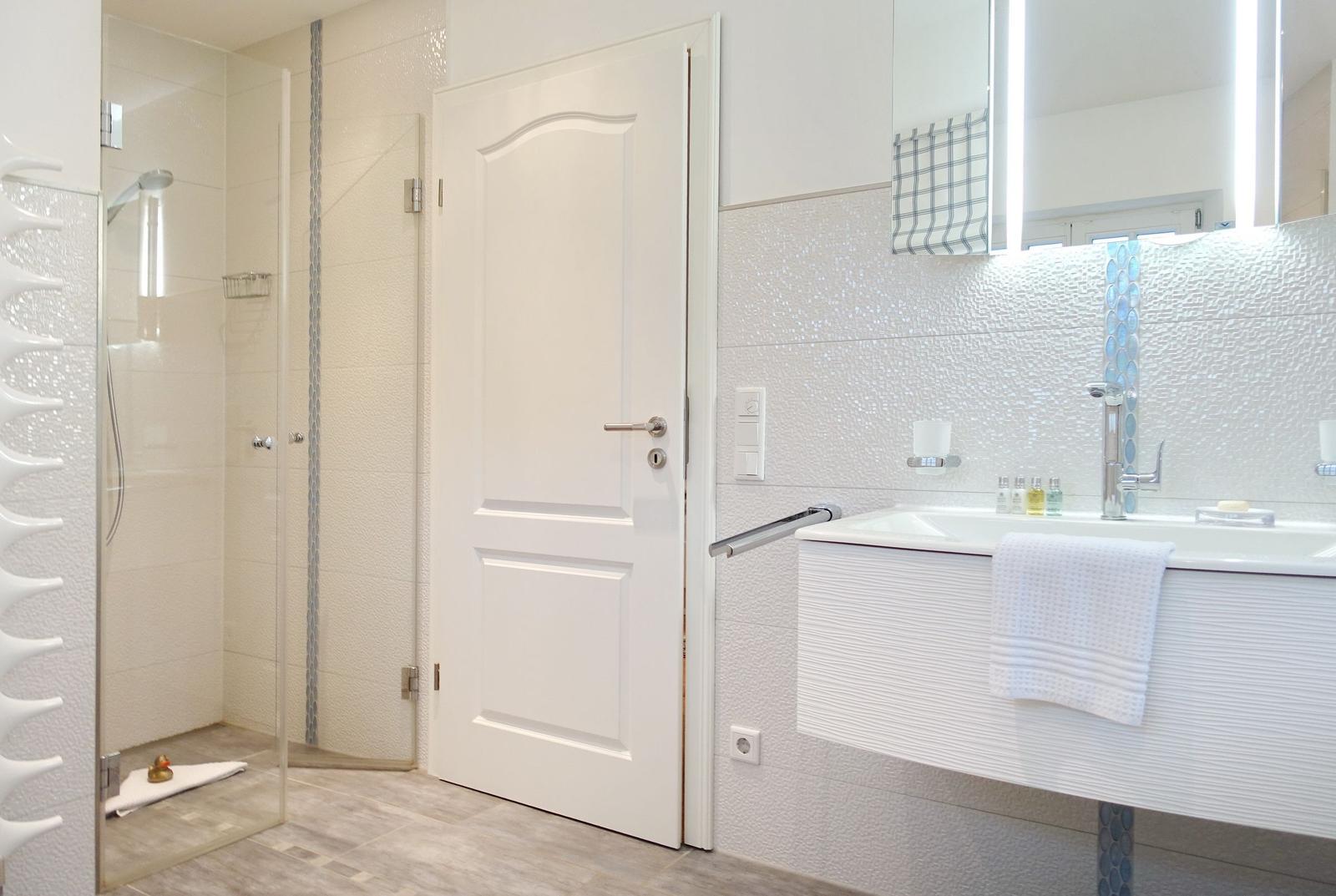Bathroom with shower, sink, and mirror