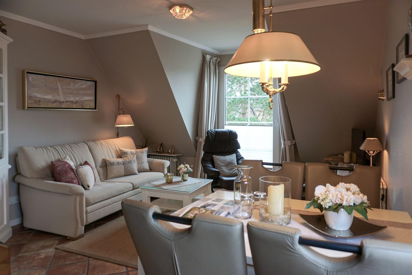 Living and dining area with sofa, dining table, and window