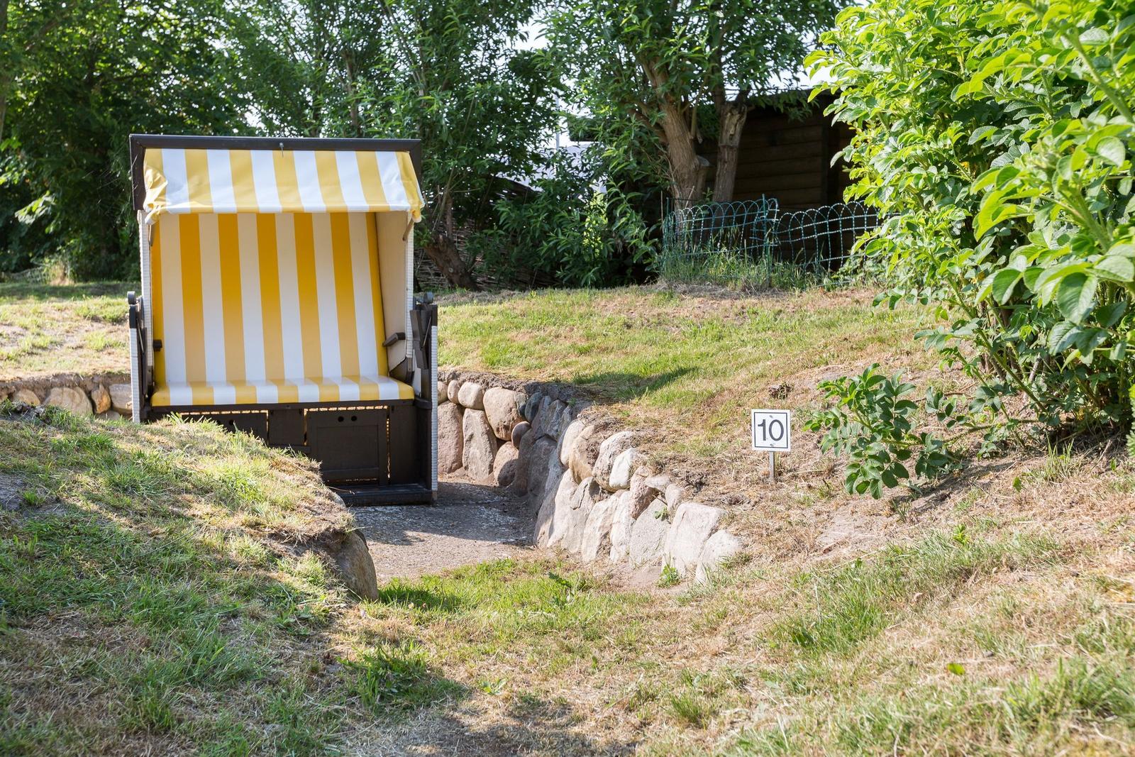 Yellow-white beach chair with number 10 in the grass