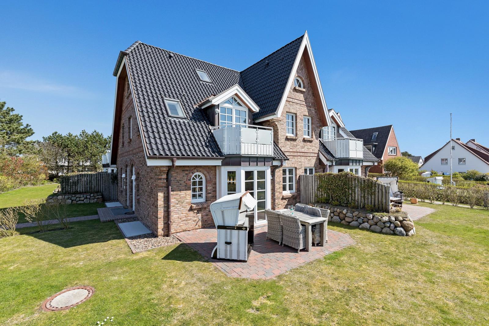 House with terrace, grill, and garden. Modern design with wooden and stone cladding.