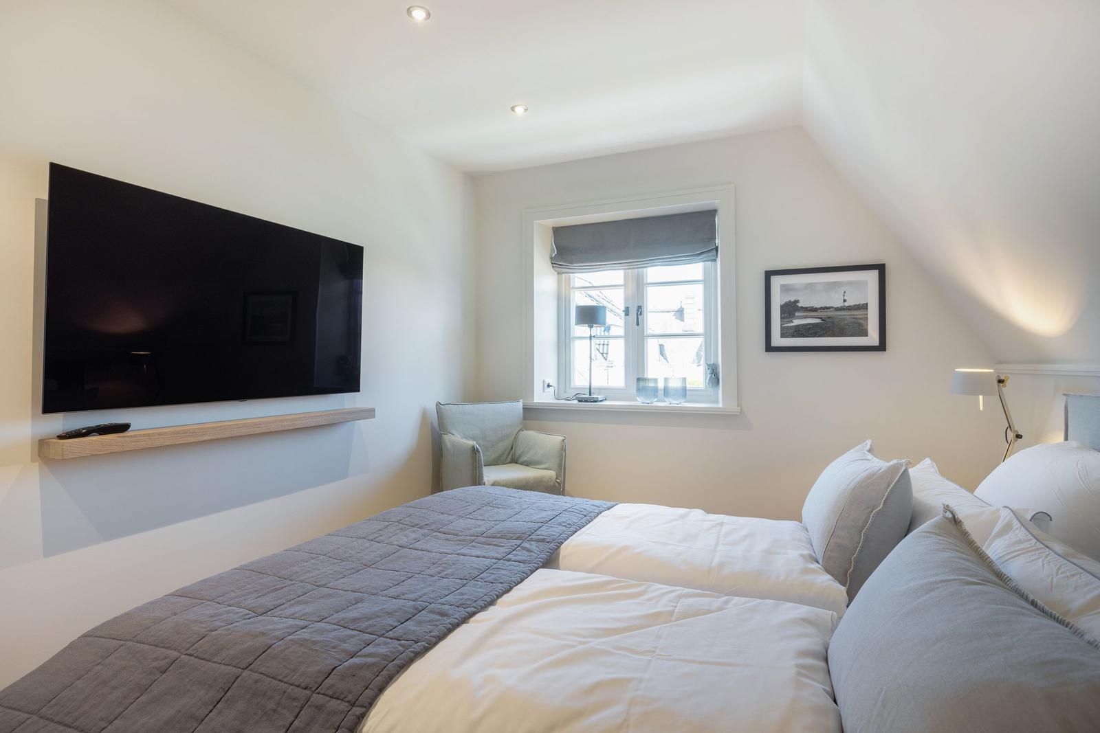 Bedroom with double bed, TV, and window