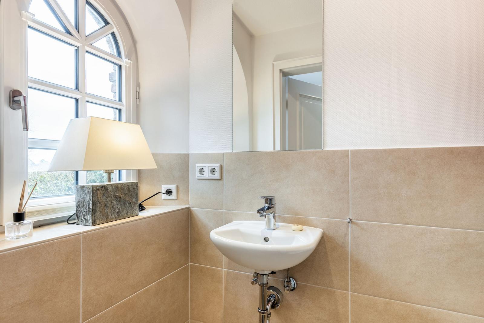 Bathroom with sink, mirror, and window